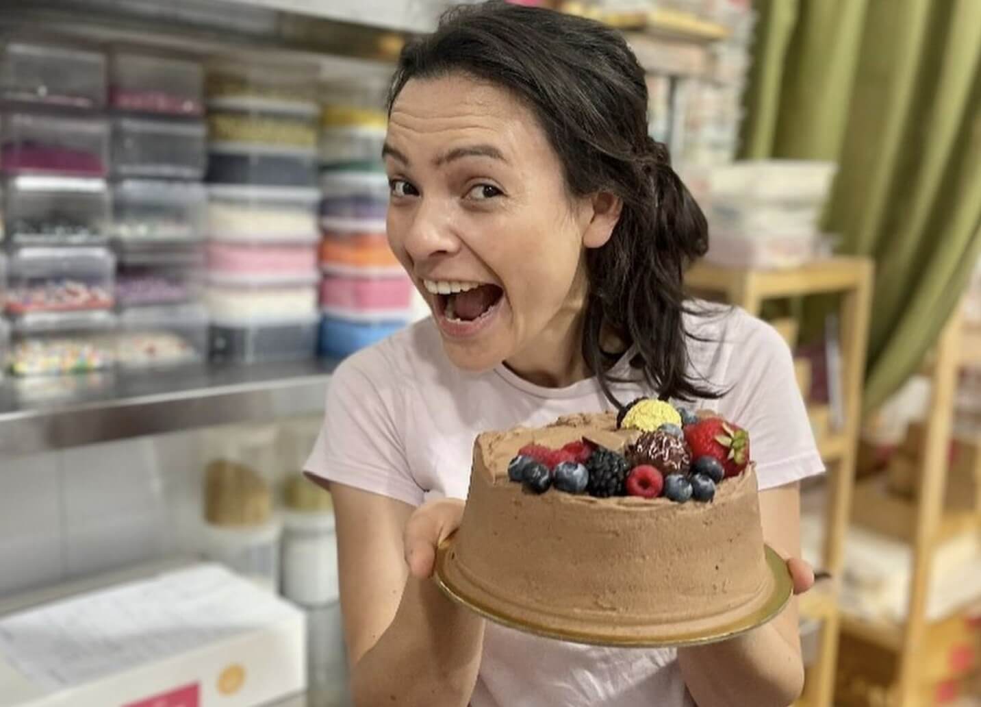 Gabriela with one of the cakes she baked for Harry Styles. Image via Instagram