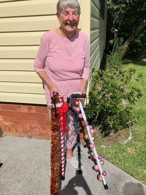 Val with her collection of walking sticks. Image supplied.